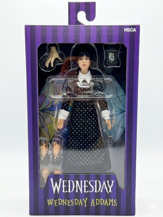 Wednesday Addams action figure in packaging with purple and white striped design